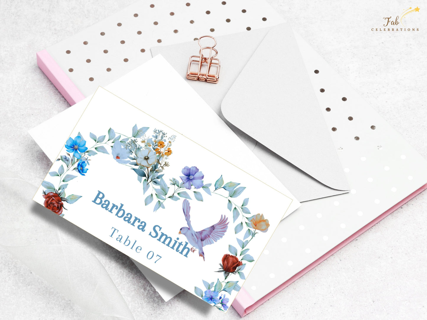 Watercolor-inspired wedding place card featuring soft blue floral details, a symbolic dove and romantic artwork that complements a coordinated wedding suite.
