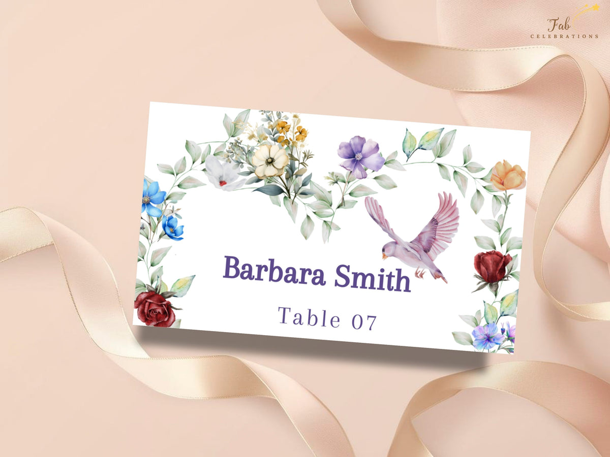 Wedding place card featuring a graceful dove surrounded by watercolor-inspired colorful blossoms and soft greenery, with the guest name Barbara Smith and table number 07.