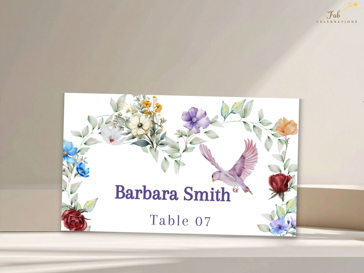 Elegant wedding place card featuring watercolor-inspired colorful flowers and soft greenery with a graceful dove, personalized with the guest name Barbara Smith and table number 07.