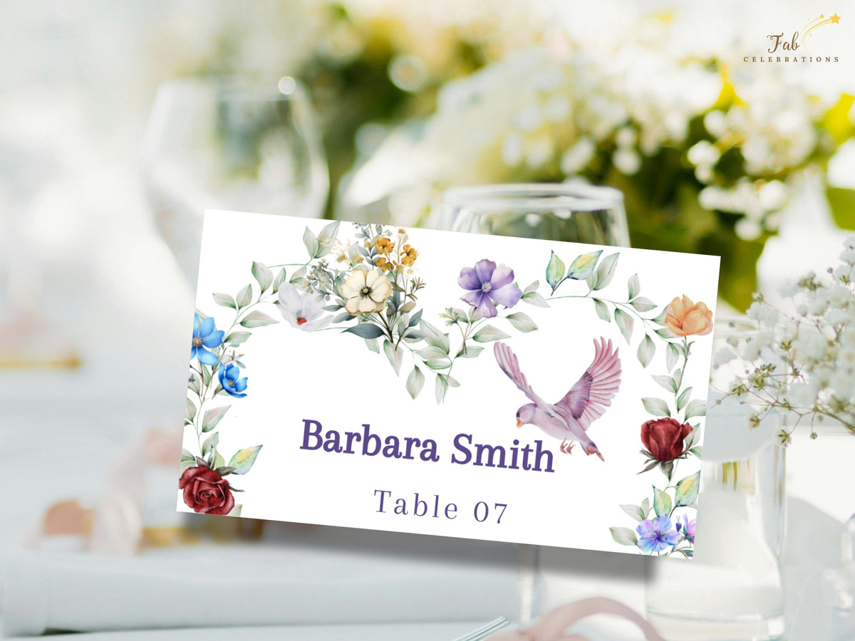 Floral wedding place card featuring watercolor-inspired garden blossoms, delicate leafy greenery and a graceful dove framing the guest name Barbara Smith and reception table number 07.
