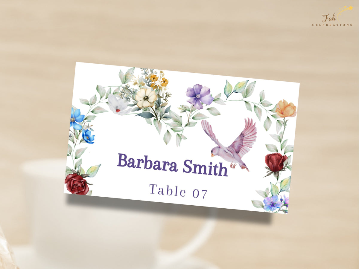 Romantic wedding name card featuring watercolor-inspired multicolored flowers, delicate greenery and a graceful dove framing the guest name Barbara Smith and table number 07.