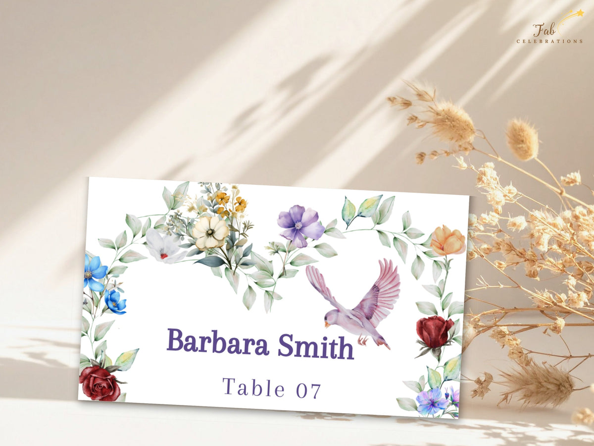 Wedding place card featuring watercolor-inspired colorful flowers, delicate leafy greenery and a graceful dove framing the guest name Barbara Smith with the reception table number 07.