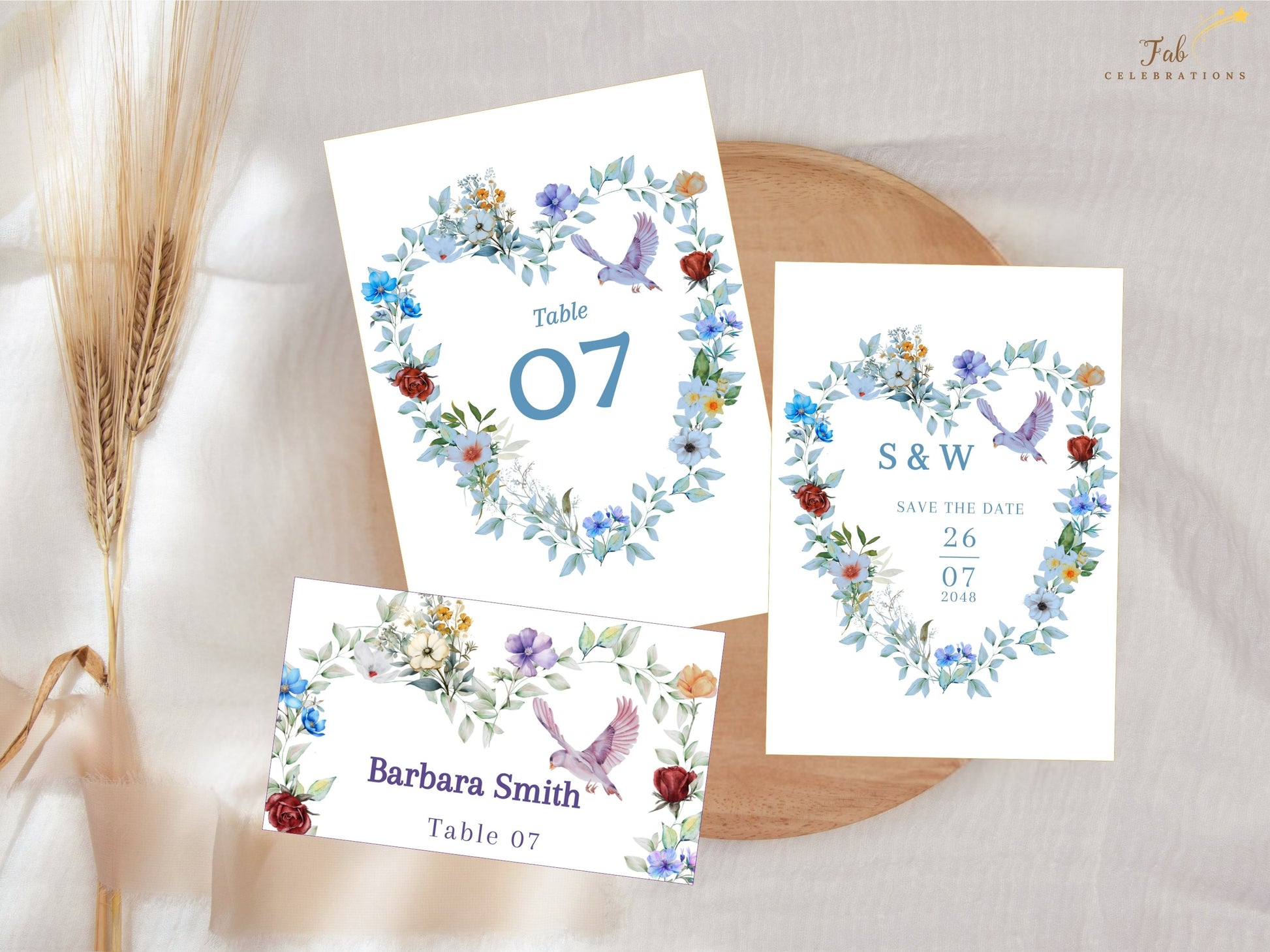 Watercolor-inspired wedding invitation suite with blue floral heart decorations, symbolic doves and elegant stationery pieces designed to bring harmony to your celebration.