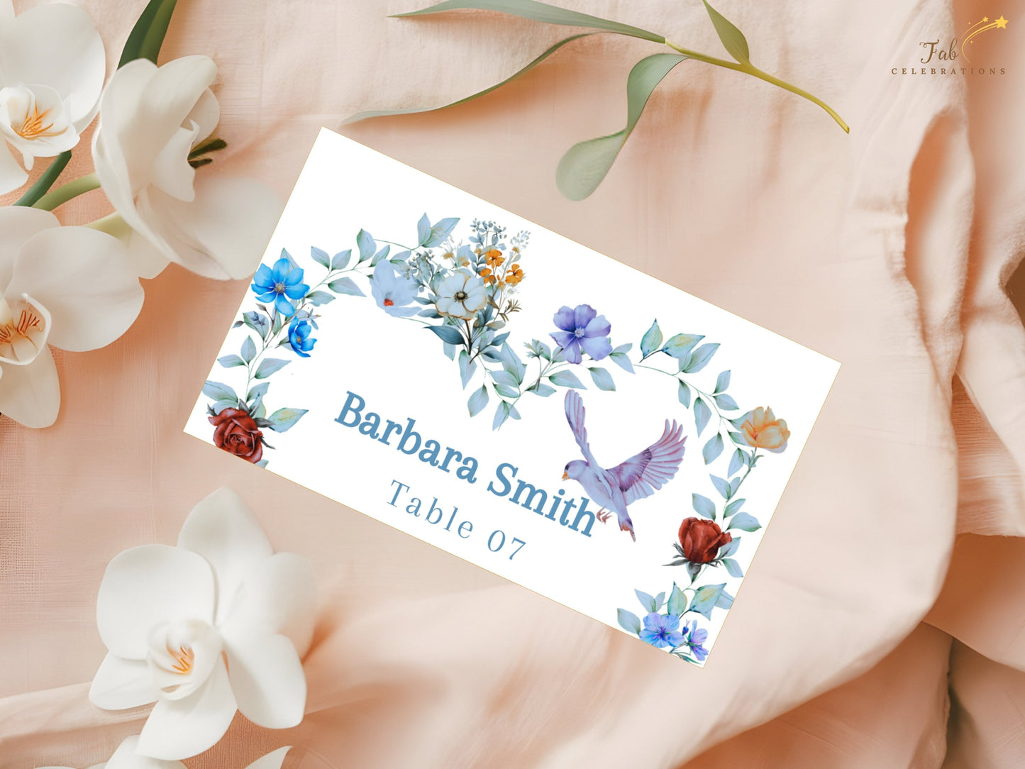 Blue floral place card template with elegant botanical decorations and editable Canva format designed for sophisticated wedding reception table settings.