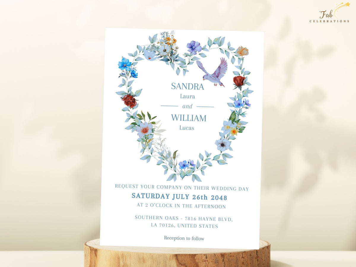 Wedding invitation front featuring watercolor-inspired blue and ivory florals, delicate greenery and two doves forming an elegant heart wreath around the couple names and wedding information.