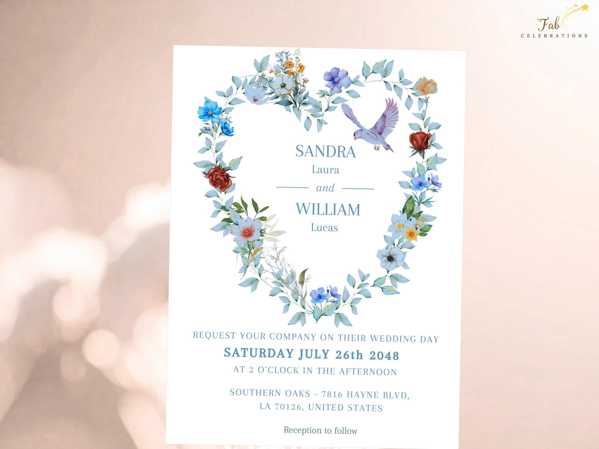 Wedding invitation front featuring delicate watercolor-inspired blue florals, greenery and two doves forming a romantic heart wreath around the couple names and coordinated wedding details.