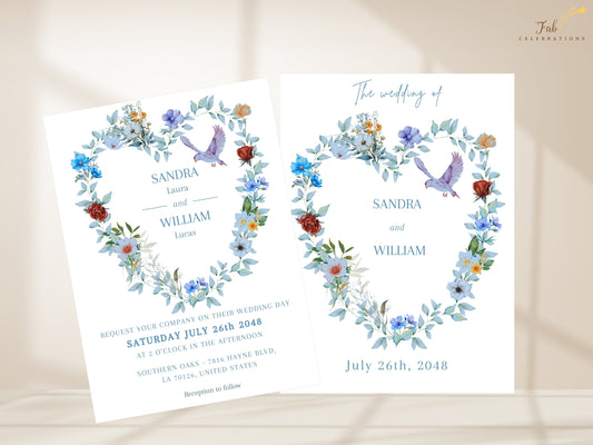 Elegant Boho Wedding Invitation shown with the invitation front and coordinated text back, featuring a watercolor-inspired floral heart wreath, dusty blue blooms, greenery and graceful dove illustrations.