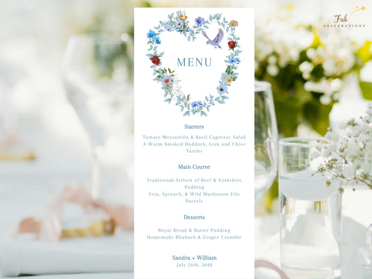 Elegant Wedding Menu Card featuring a watercolor-inspired floral heart wreath with blue flowers, green foliage, delicate butterflies and a graceful dove above organized starter, main course, dessert and drink selections.