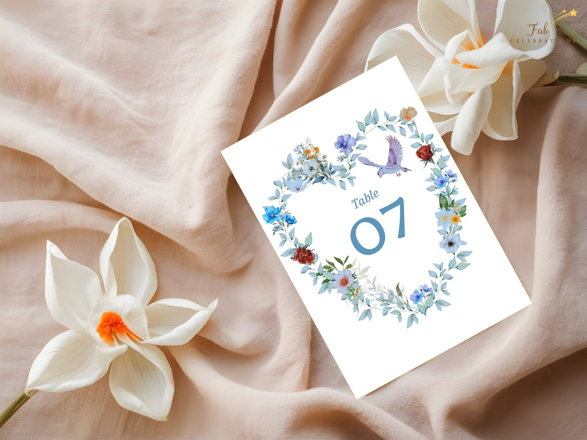 Watercolor-inspired wedding table number card featuring blue floral details, a symbolic dove and romantic artwork that complements a coordinated wedding suite.