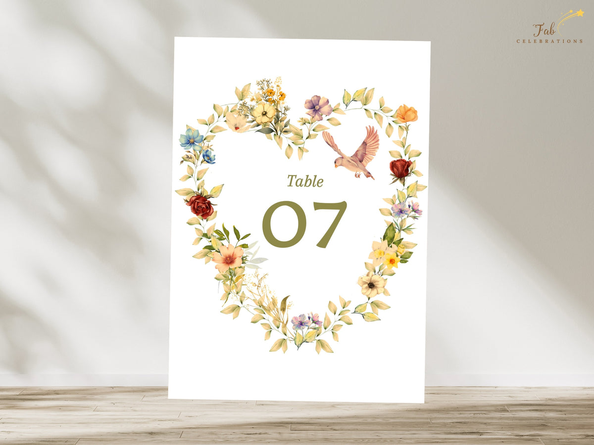Floral dove wedding table number card with a watercolor-inspired heart arrangement, golden and blush blooms, delicate greenery, and an editable table 07 for an elegant wedding reception.