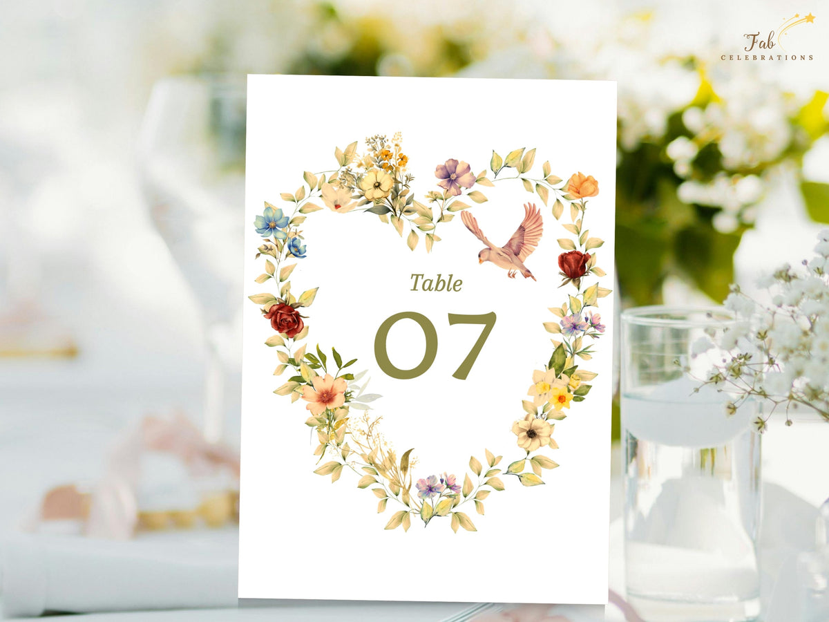 Floral heart wedding table number displayed with watercolor-inspired flowers, two doves, and an elegant olive green table 07, offering a romantic botanical look for reception seating.