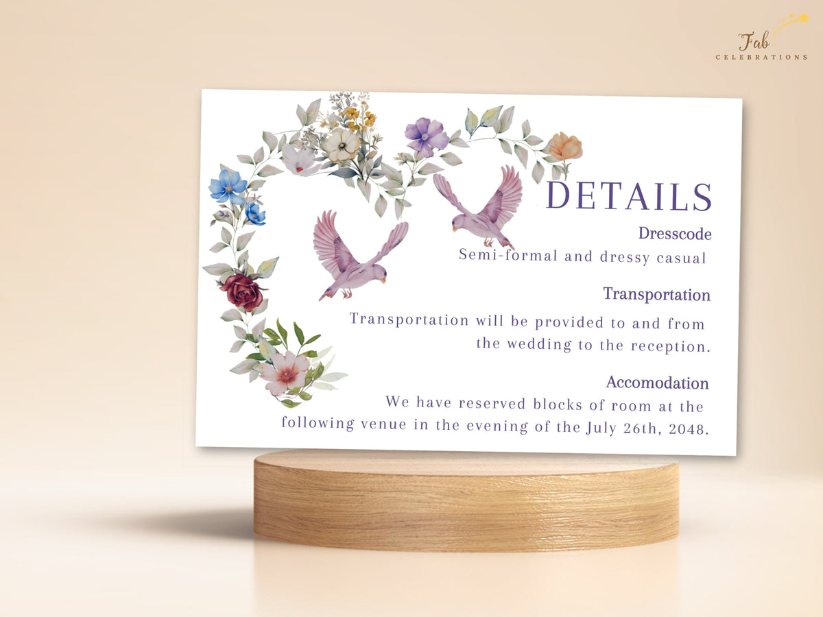 Floral heart wedding details card displayed with watercolor-inspired blooms, pink doves and purple lettering, offering an editable Canva layout for guest information. Editable in Canva.
