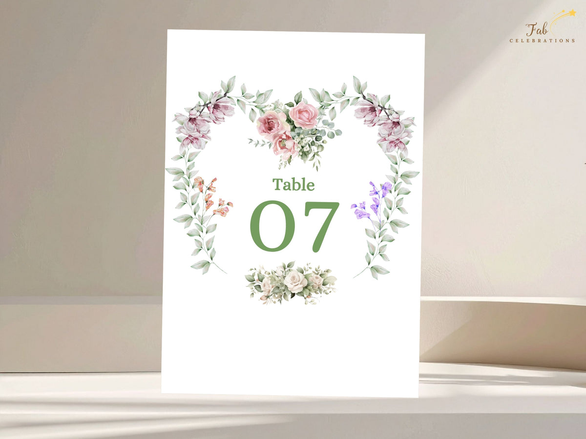 Botanical wedding table number card featuring Table 07 framed by watercolor-inspired pink roses, purple blossoms, leafy greenery and graceful floral accents for the reception.