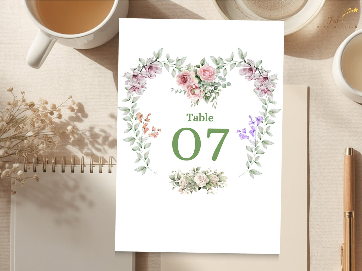 Elegant wedding table number card featuring Table 07 framed by watercolor-inspired pink roses, purple flowers, greenery and delicate botanical details in a coordinated floral design.