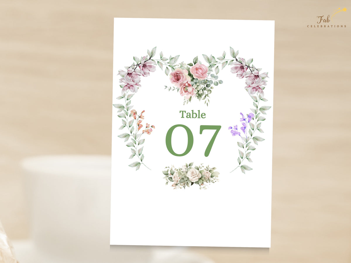 Reception table number card featuring Table 07 with a watercolor-inspired floral heart wreath, combining romantic pink flowers, purple blossoms and delicate botanical greenery.