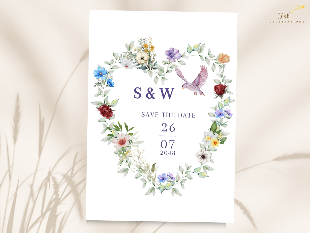 French Countryside Wedding save the date card featuring a watercolor-inspired floral heart with colorful blossoms, soft greenery and a graceful dove surrounding the couple's initials and wedding date.