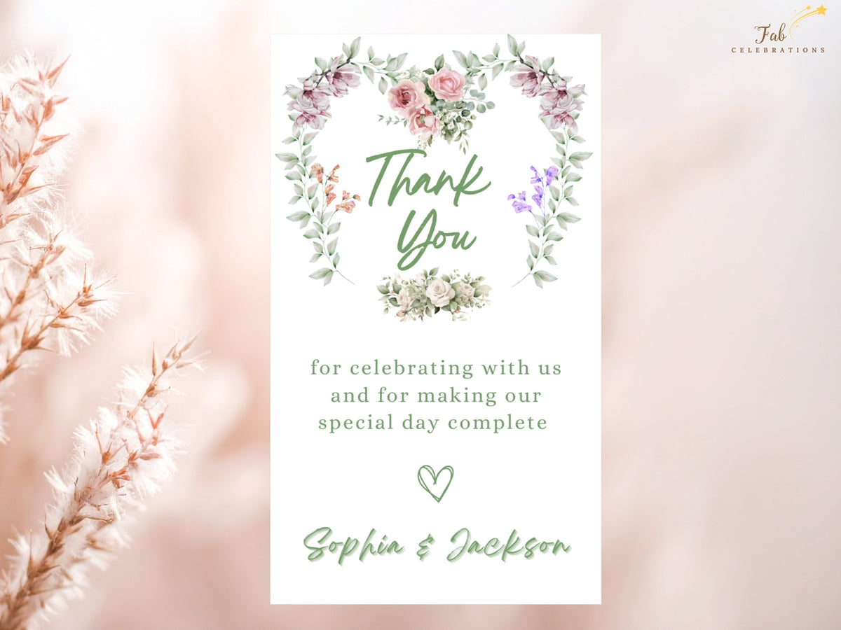 Wedding thank-you card featuring a watercolor-inspired floral heart wreath, graceful Thank You lettering, a heartfelt message and personalized couple names in a coordinated romantic design.