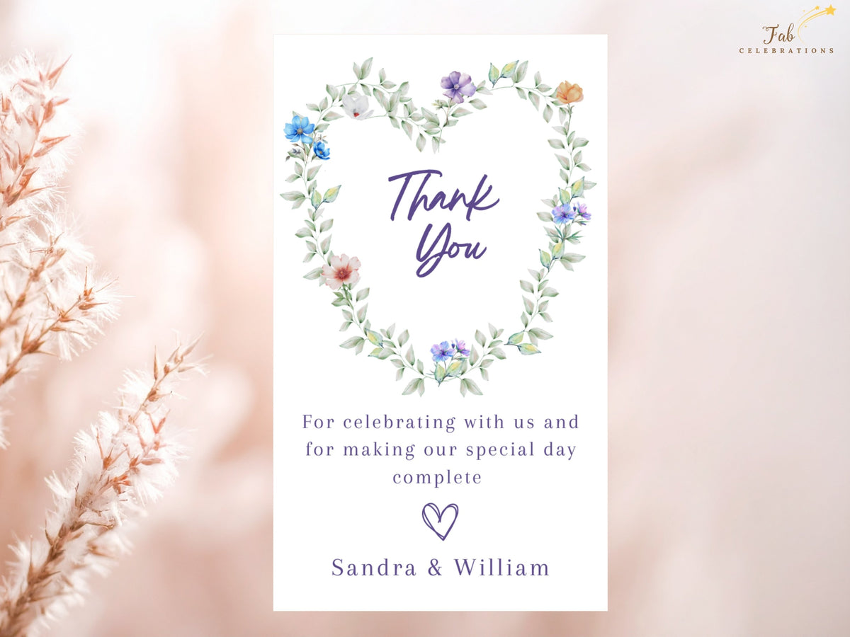 Wedding thank you card featuring a watercolor-inspired floral heart wreath, elegant purple Thank You lettering and a personalized message for guests, coordinated with the complete romantic wedding stationery collection.
