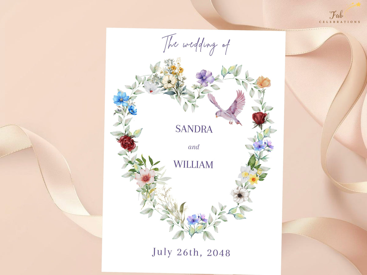 Wedding invitation front featuring a watercolor-inspired heart of delicate blue, purple, red, peach and white flowers with soft greenery and a graceful dove around elegant wedding typography.