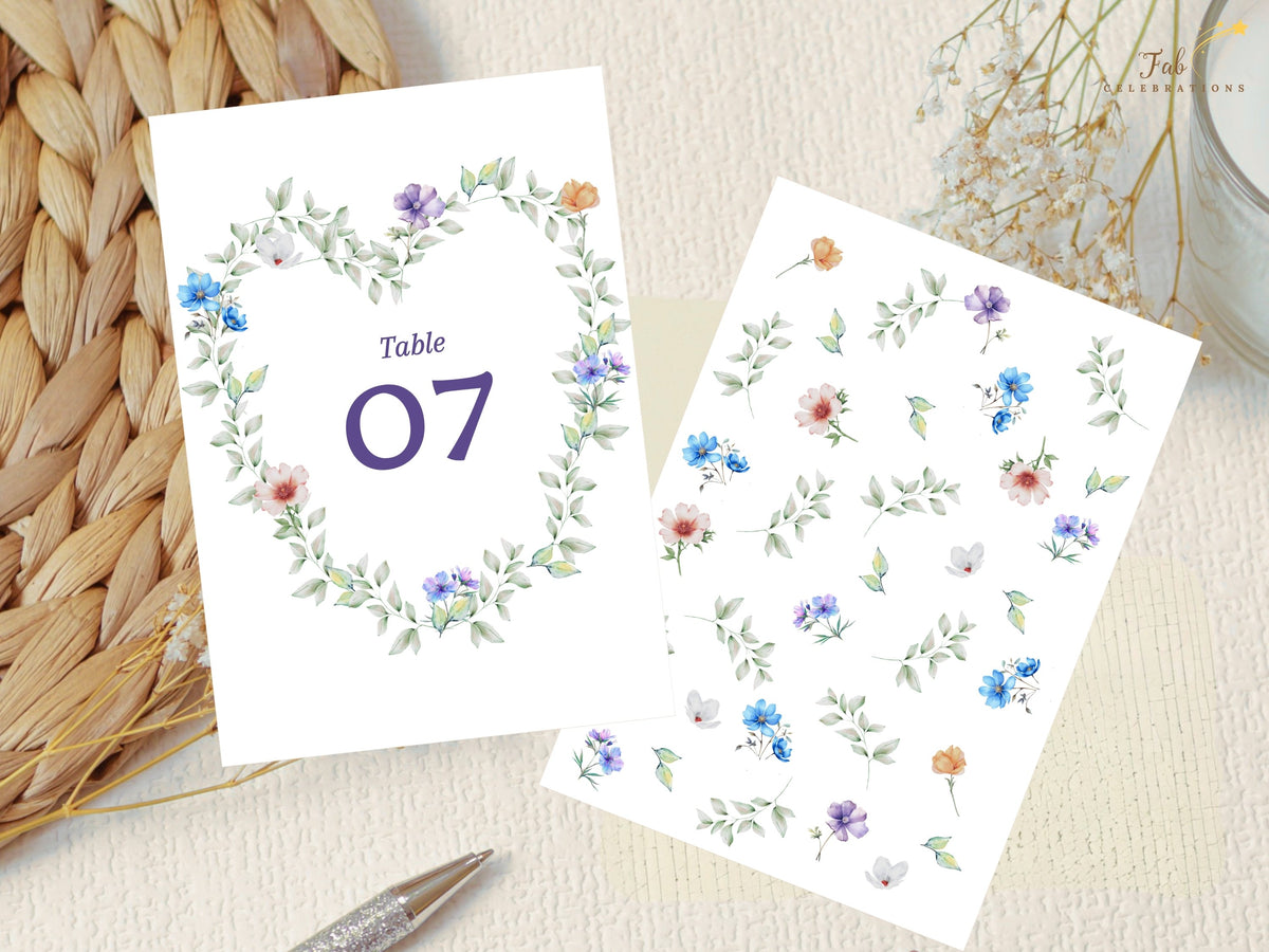 Pastel Garden Table Number shown beside the individual watercolor-inspired floral elements used in the design, including airy greenery and delicate blue, purple, white, peach and pink flowers.