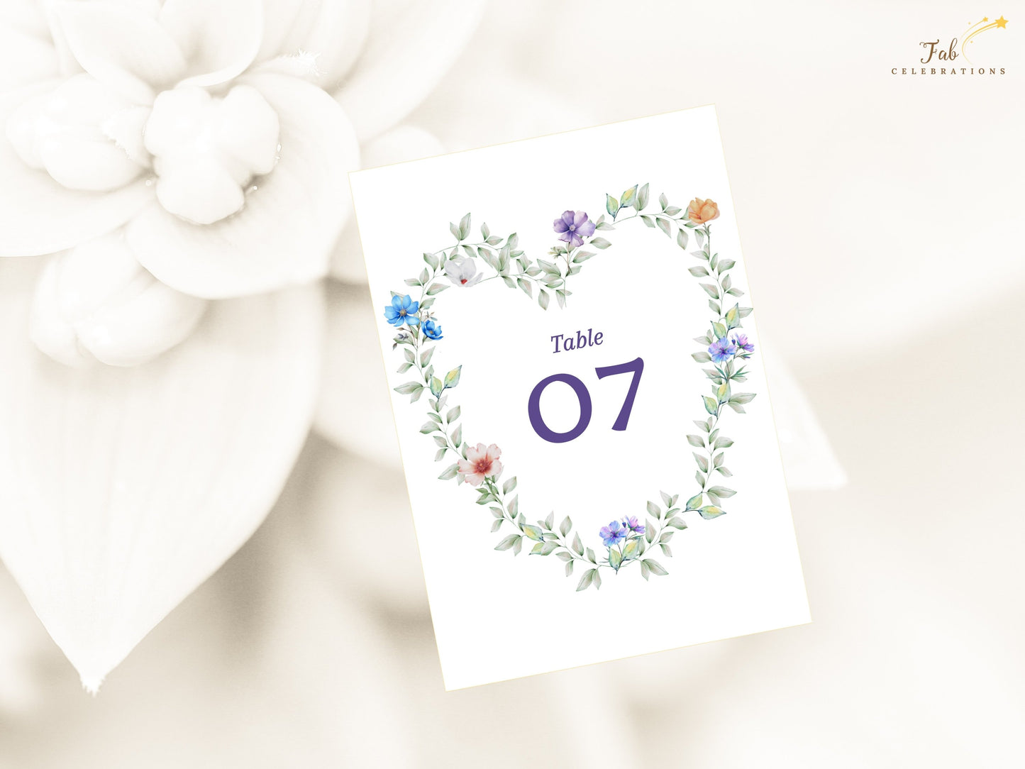 Pastel Garden Table Number Canva template featuring soft lavender, blush and blue flowers arranged in a graceful floral heart design for weddings.