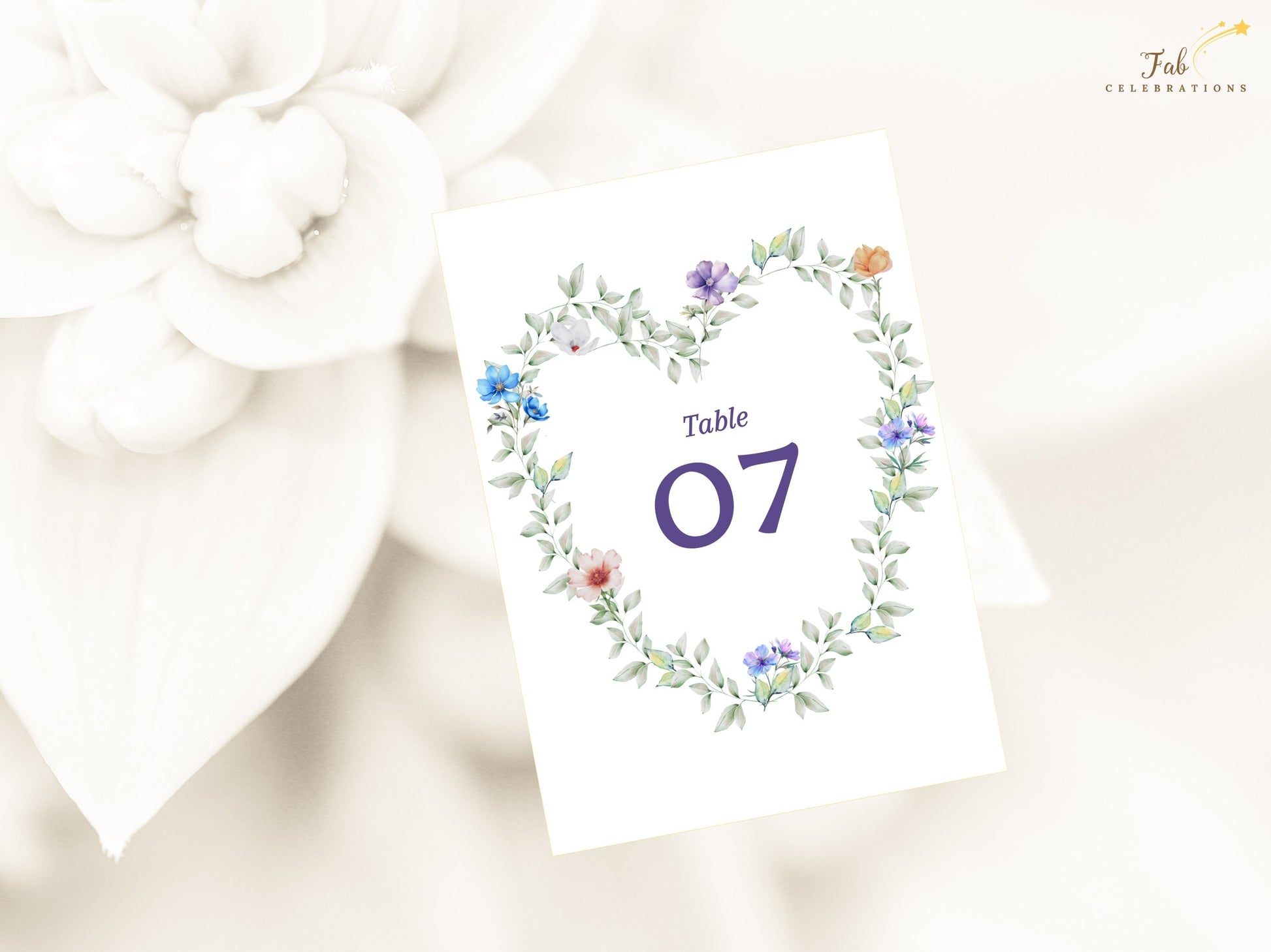 Pastel Garden Table Number Canva template featuring soft lavender, blush and blue flowers arranged in a graceful floral heart design for weddings.