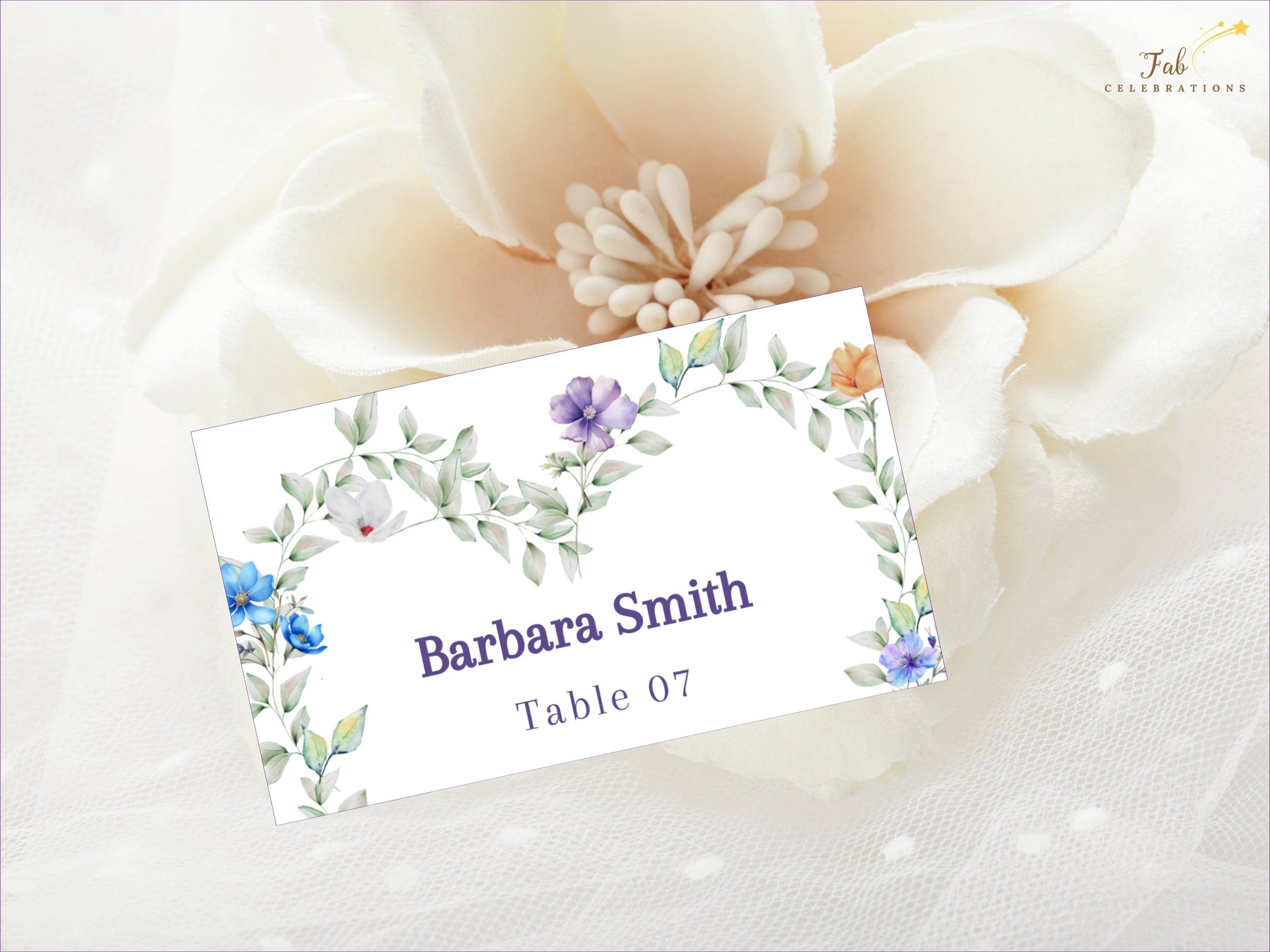 Pastel Wedding Name Card editable Canva template featuring a romantic heart-shaped floral wreath with pastel flowers and greenery for elegant wedding seating.