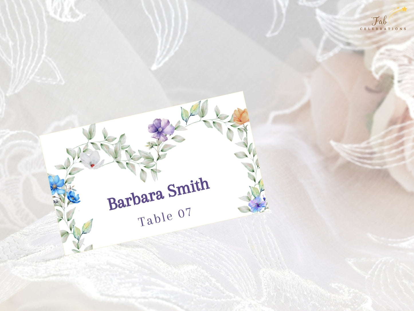 Pastel Wedding Name Card editable wedding seating card featuring pastel lavender, peach and blue flowers arranged in a graceful heart design.