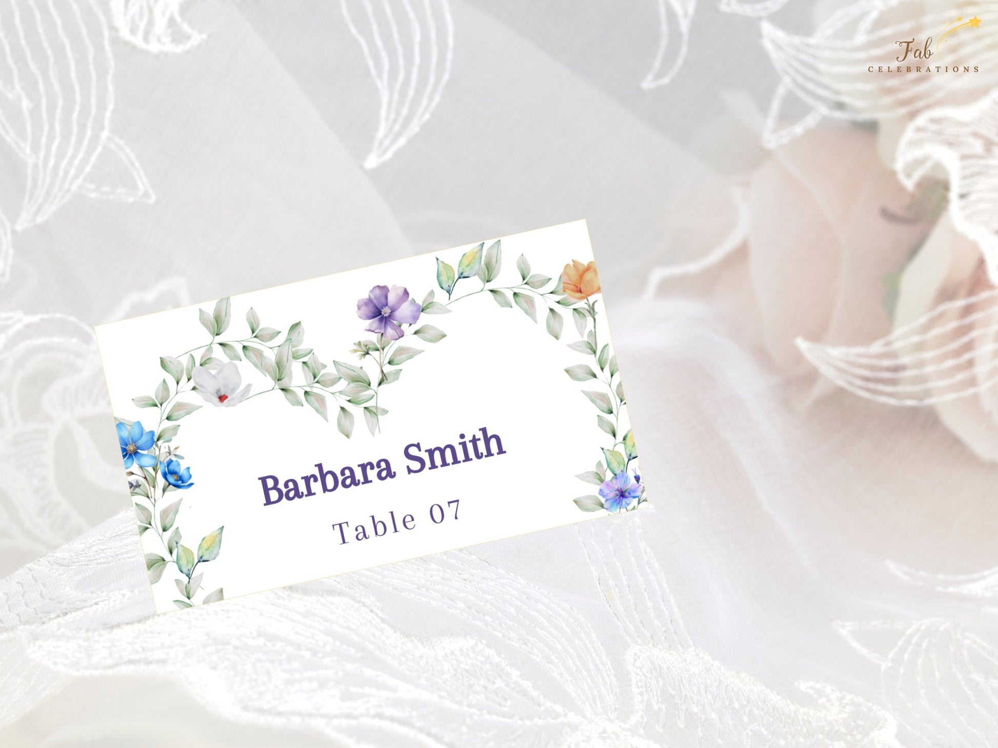 Pastel Wedding Name Card editable wedding seating card featuring pastel lavender, peach and blue flowers arranged in a graceful heart design.