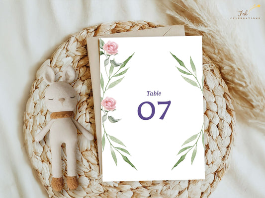 Pink rose wedding table number card template with watercolor blush roses and greenery — editable Canva design for guiding guests with elegance and floral harmony.