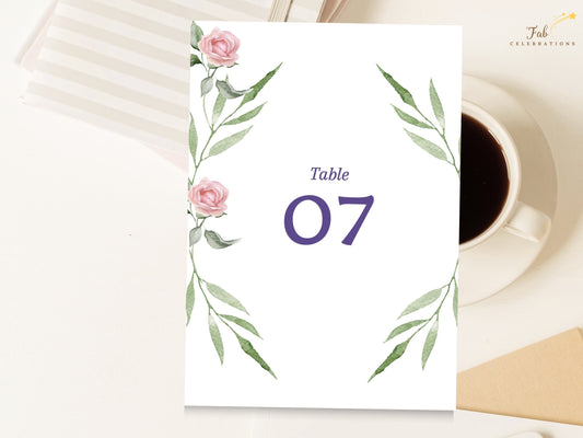 Pink Rose Wedding Table Number Card featuring watercolor-inspired blush pink roses and graceful green foliage framing a bold purple table number for an elegant coordinated reception display.