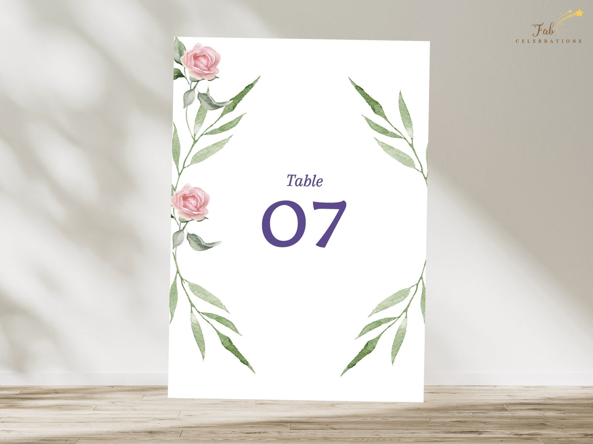 Pink floral wedding table number card featuring watercolor-inspired roses and graceful green leaves around a bold purple number for an elegant and coordinated reception setting.