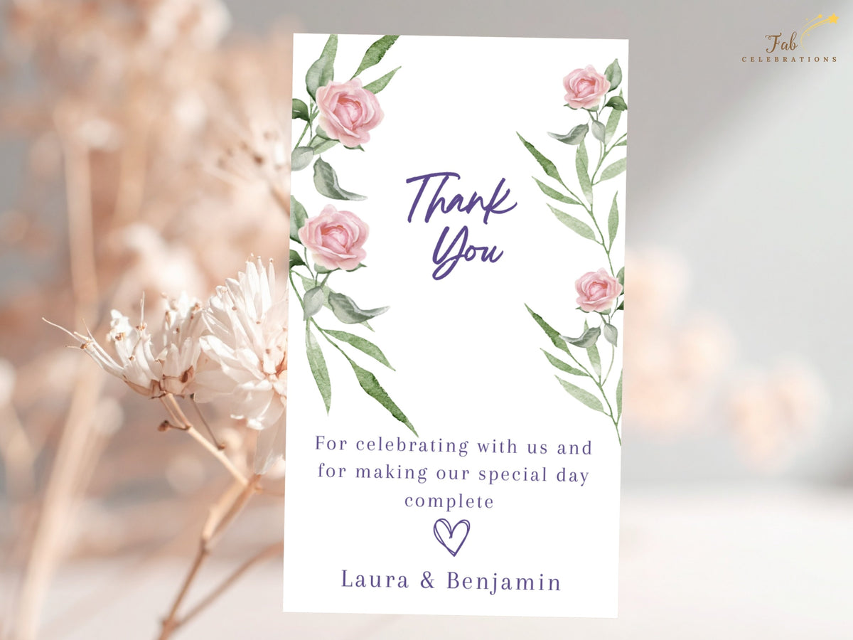 Elegant floral wedding thank you card featuring watercolor-inspired blush pink roses and green foliage, with refined purple typography and a warm message thanking guests for celebrating.