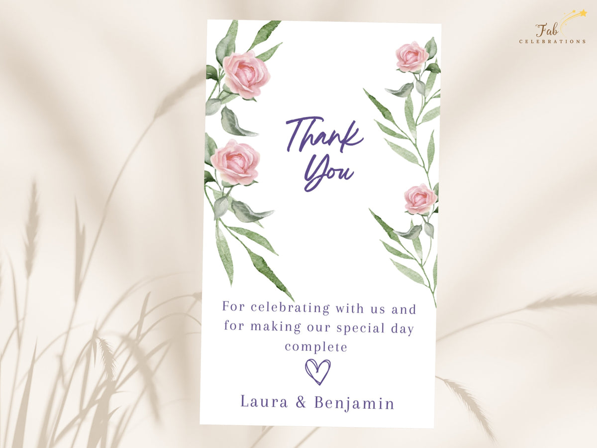 Pink botanical gratitude card decorated with watercolor-inspired roses and leafy green accents, featuring elegant purple Thank You script, a heartfelt message and personalized couple names.