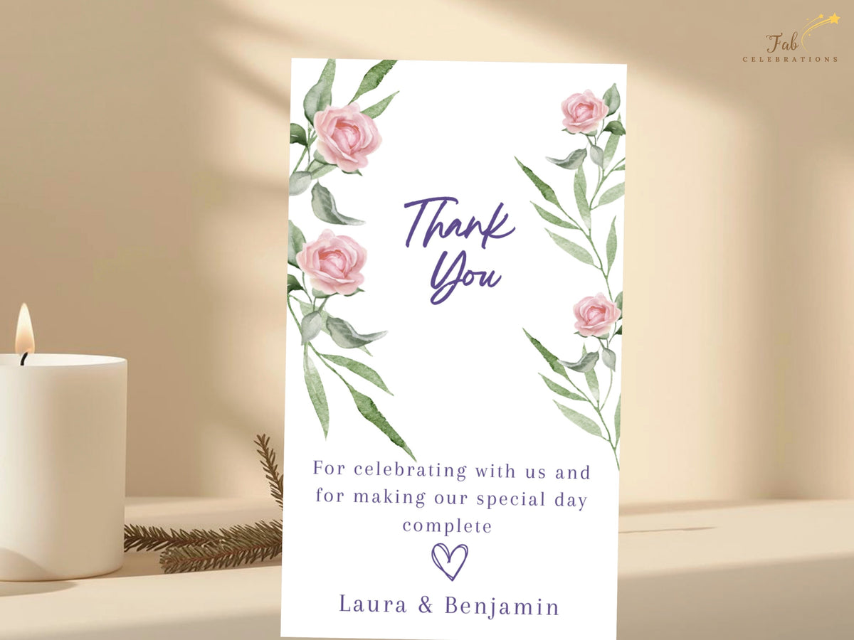 Refined wedding thank you card decorated with watercolor-inspired blush roses and graceful green leaves, combining elegant purple lettering with a personal message of appreciation.