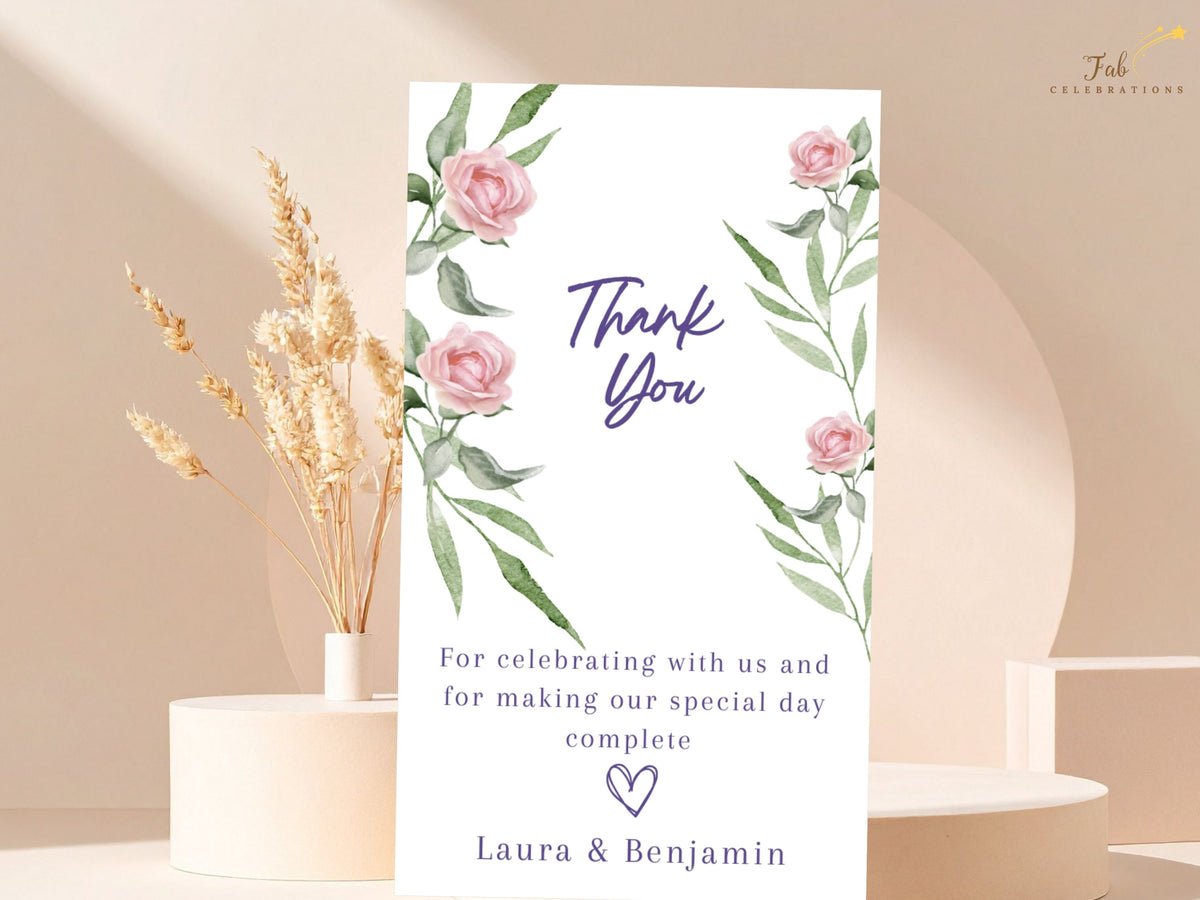 Soft pink floral thank you note decorated with watercolor-inspired blush roses and airy green leaves, featuring elegant purple typography and a warm message of appreciation for wedding guests.