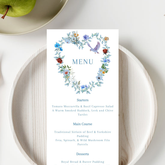 Video presentation of the Elegant Wedding Menu Card featuring an editable Canva template with a watercolor-inspired blue floral heart design, graceful dove motif, romantic botanical artwork and elegant reception dining styling.