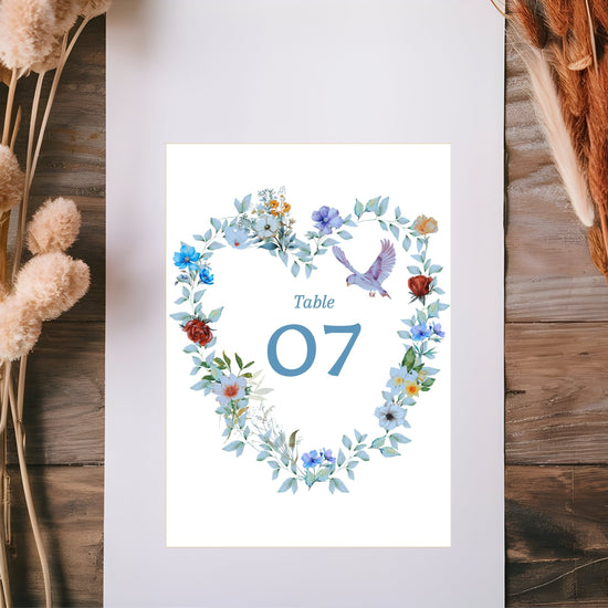 Video presentation of the Elegant Wedding Table Number Card featuring an editable Canva template with a watercolor-inspired blue floral heart design, graceful dove motif, romantic botanical artwork and elegant reception styling.