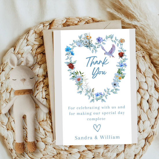 Video presentation of the Elegant Wedding Thank You Card featuring an editable Canva template with a watercolor-inspired blue floral heart wreath, graceful dove motif, romantic botanical artwork and elegant gratitude styling.