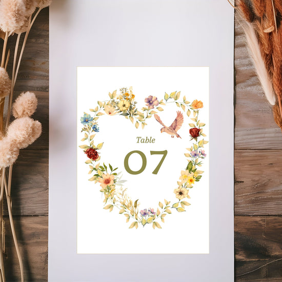 Video showcasing the Romantic Wedding Table Number featuring a watercolor-inspired floral heart wreath, graceful dove illustration, soft beige background and editable Canva template for elegant coordinated wedding receptions.