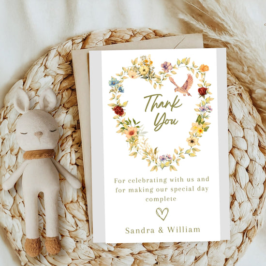 Video showcasing the Romantic Wedding Thank You Card featuring a watercolor-inspired floral heart wreath, graceful dove illustration, soft beige background and editable Canva template for elegant wedding stationery.