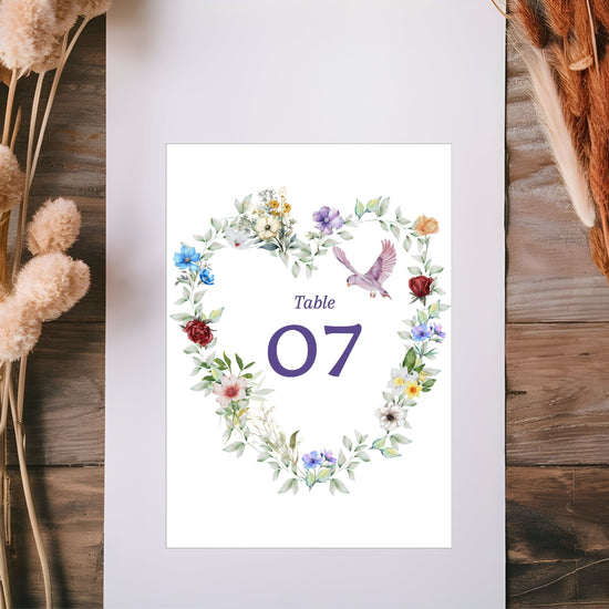 Canva tutorial showing editable wedding table number cards with floral heart design, graceful dove motif and delicate greenery for elegant French-inspired receptions.