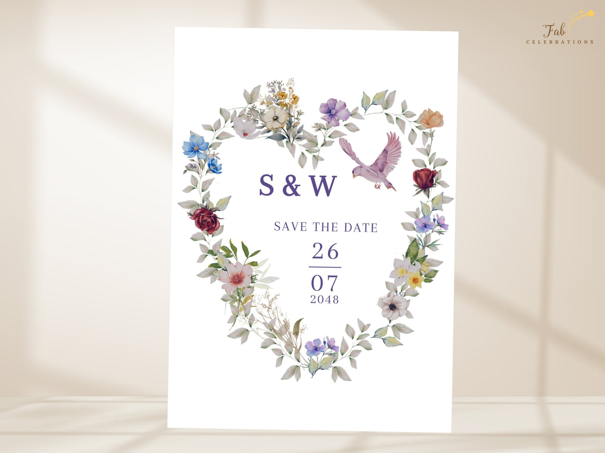 Watercolor-inspired floral heart save the date with soft purple blooms, blue wildflowers, blush accents and a pink dove, designed to announce the wedding with personalized initials and date.