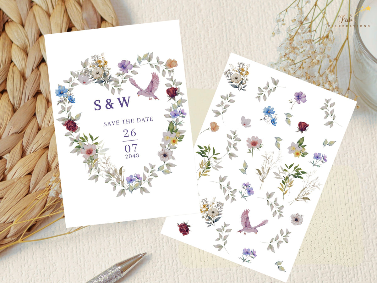 Save the date card presented beside its coordinating watercolor-inspired botanical artwork sheet, featuring a purple and blue floral heart, delicate greenery and a pink dove used in the design.