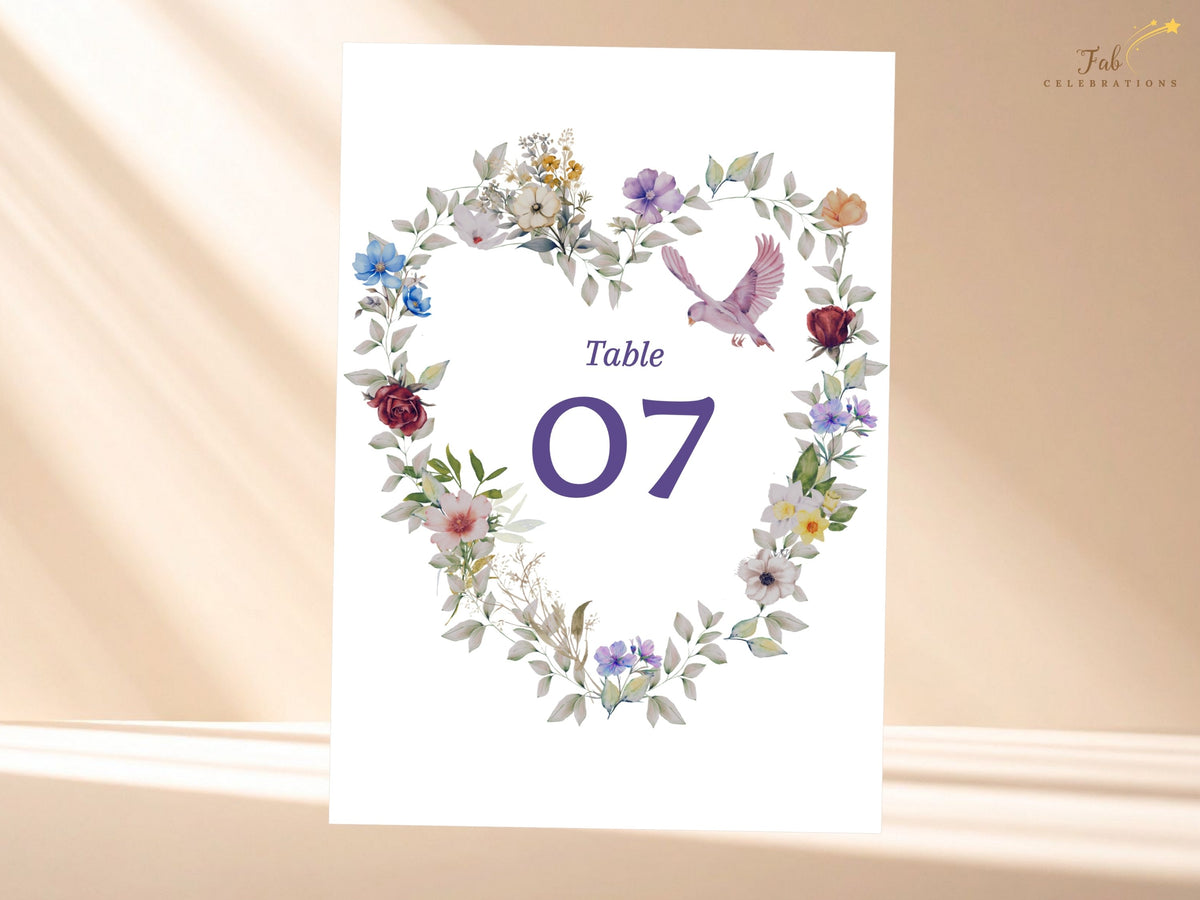 Floral wedding table number card with a bold purple seven framed by watercolor-inspired garden flowers, subtle greenery and a dove for coordinated reception stationery. Editable in Canva.