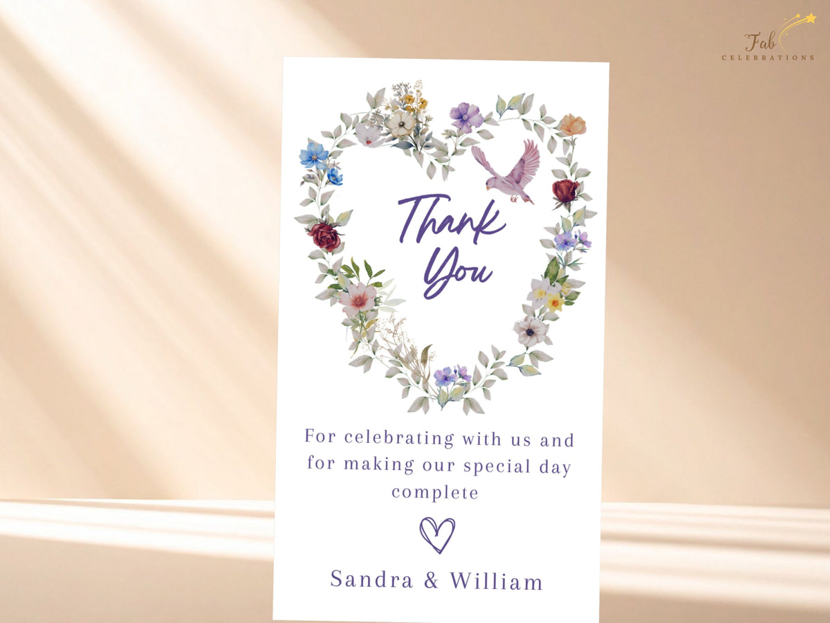 Coordinated wedding thank you card featuring a watercolor-inspired botanical heart, purple Thank You lettering, a soft pink dove and a customizable note that matches the floral wedding suite.