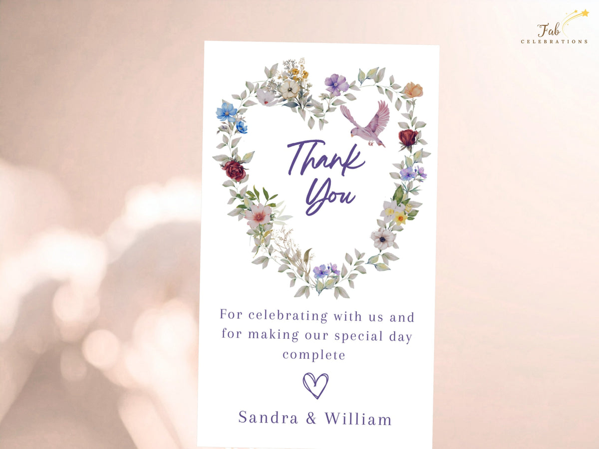 Floral wedding gratitude card framed by watercolor-inspired purple, blue and blush blossoms, with a pink dove above the words Thank You and a heartfelt editable note signed by the couple.