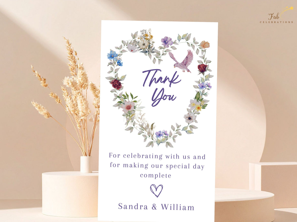 Editable wedding gratitude card featuring watercolor-inspired colorful blossoms arranged in a heart, a pink dove, a short appreciation message and personalized names of the newly married couple.