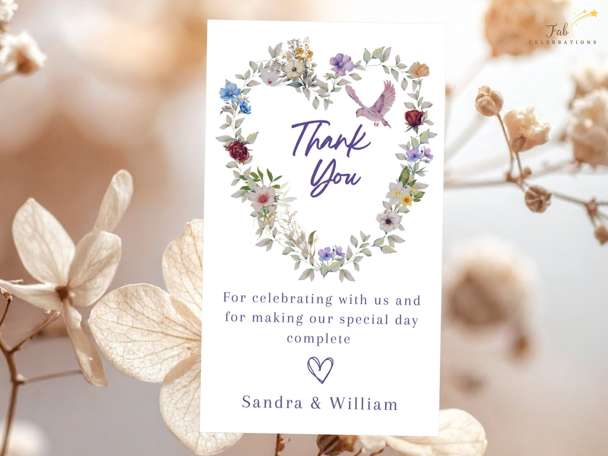 Romantic wedding thank you design with a pink dove resting above watercolor-inspired florals in a heart shape, elegant Thank You lettering and a customizable note to celebrate guests and loved ones.