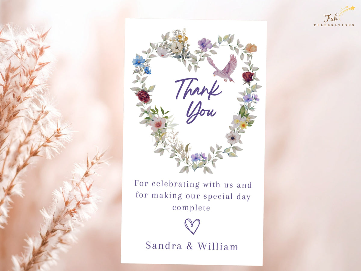 Purple Floral Wedding Thank You Card featuring a watercolor-inspired floral heart, graceful pink dove and handwritten-style Thank You lettering above a short note of appreciation from the newlyweds.